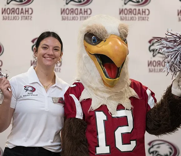 Eagle mascot and student smiling